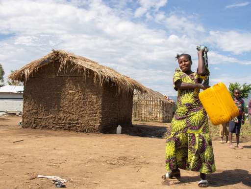 Chance carries a large canister of water 