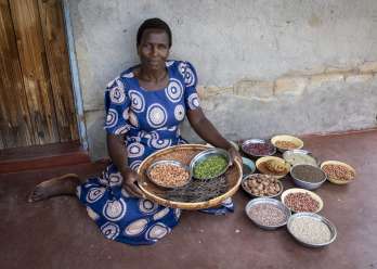 Nyarai shows off the variety of fruits and nuts harvest from the entrance of the organic store constructed through the BRACT project.
